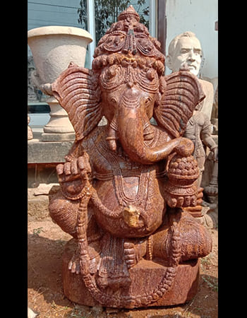 Traditional Ganesha statue with large ears symbolizing wisdom and intricate costume carving
