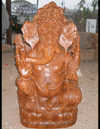Sandstone Ganesha statue in royal pose with crown and traditional Indian temple art aesthetics