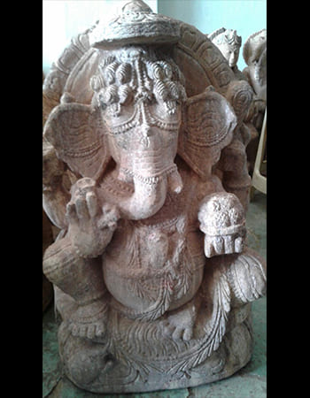 Sandstone Ganesha statue with intricate headpiece and sacred symbols for obstacle removal