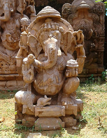 Handcrafted Lord Ganesha sculpture with traditional pose and intricate sandstone craftsmanship