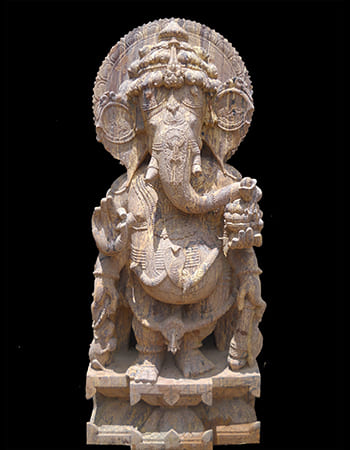 Traditional Ganesha statue with protective aura and ornamental jewelry in premium sandstone