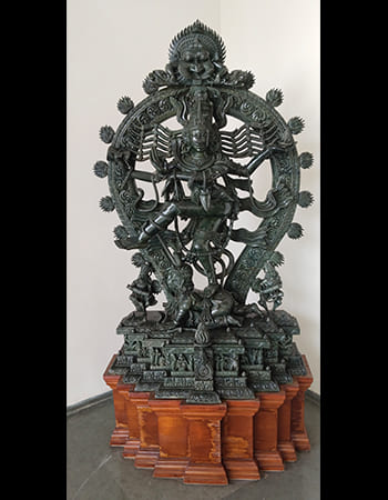Exquisite green stone sculpture of a goddess figure with multiple arms and divine attributes
