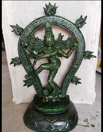 Elegant green stone carving of a standing figure with flowing drapery and graceful posture
